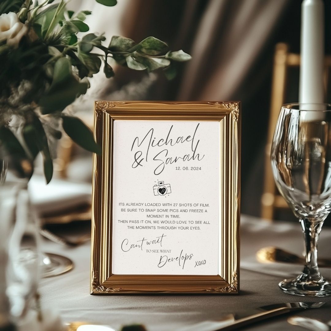 A gold frame sits on a table that has our A4 digital design framed. Showing how that print out would look in a real life wedding table.
